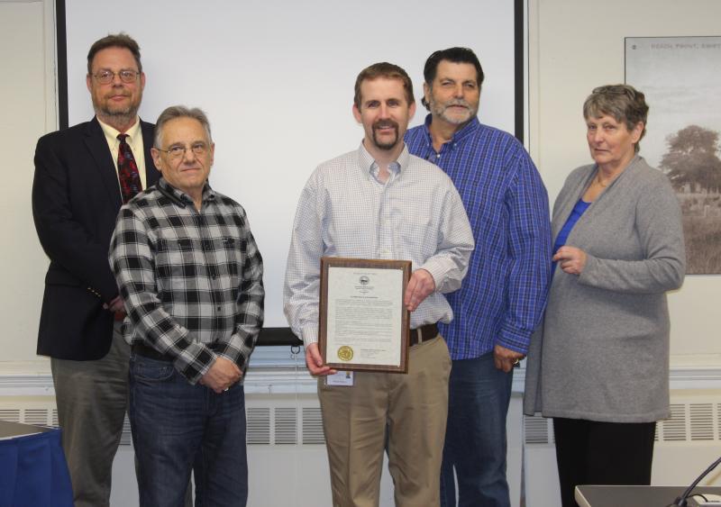 Selectmen stand with Michael O'Neill Jr., of Father Bill's & MainSpring, after recognizing the group for its efforts to combat homelessness. BY MATTHEW BERNAT